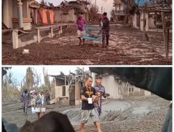 Dua Personil TNI AL Bersama Relawan Evakuasi Anjing di Reruntuhan Rumah Akibat Erupsi Gunung Ruang